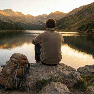 Military & Veterans 2 Person resting by a mountain lake, symbolizing peace from heavy stress and finding relief.