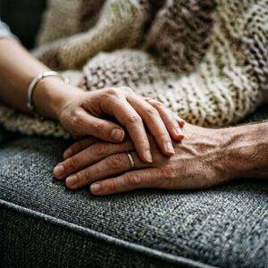 Two hands resting together, symbolizing connection and emotional support.